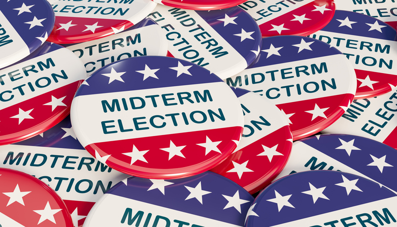 Close-up US midterm election badges with Stars and Stripes in blue and red. The text Midterm Election in the center.