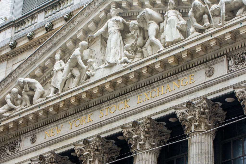 The front facade and sign of the New York Stock Exchange at wall street.